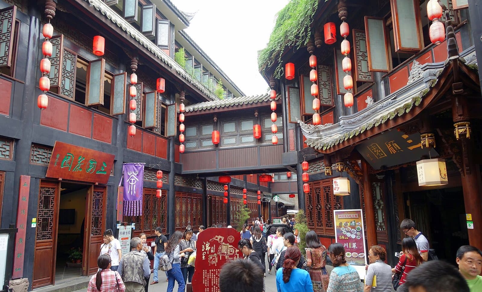 Traditional storefronts and evening lanterns on Chengdu's Jinli Street — view 2
