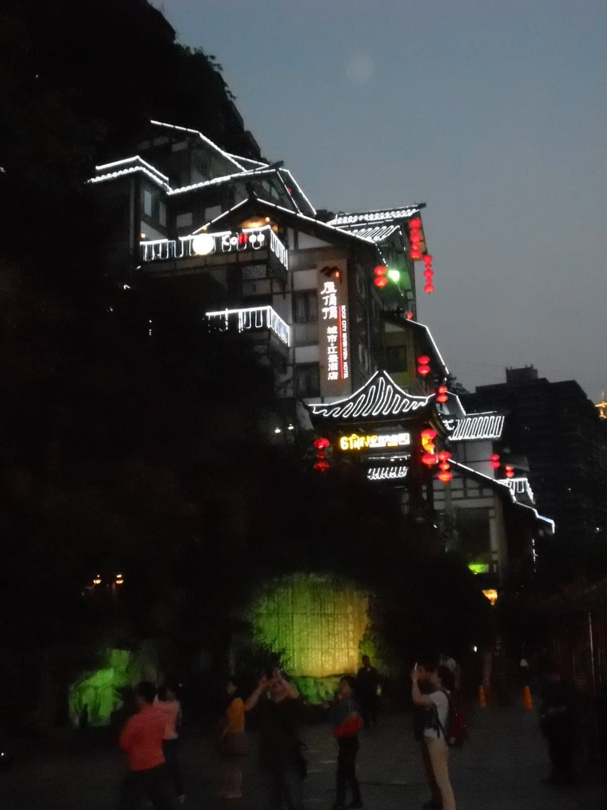 Hongya Cave illuminated above the river in Chongqing — view 2