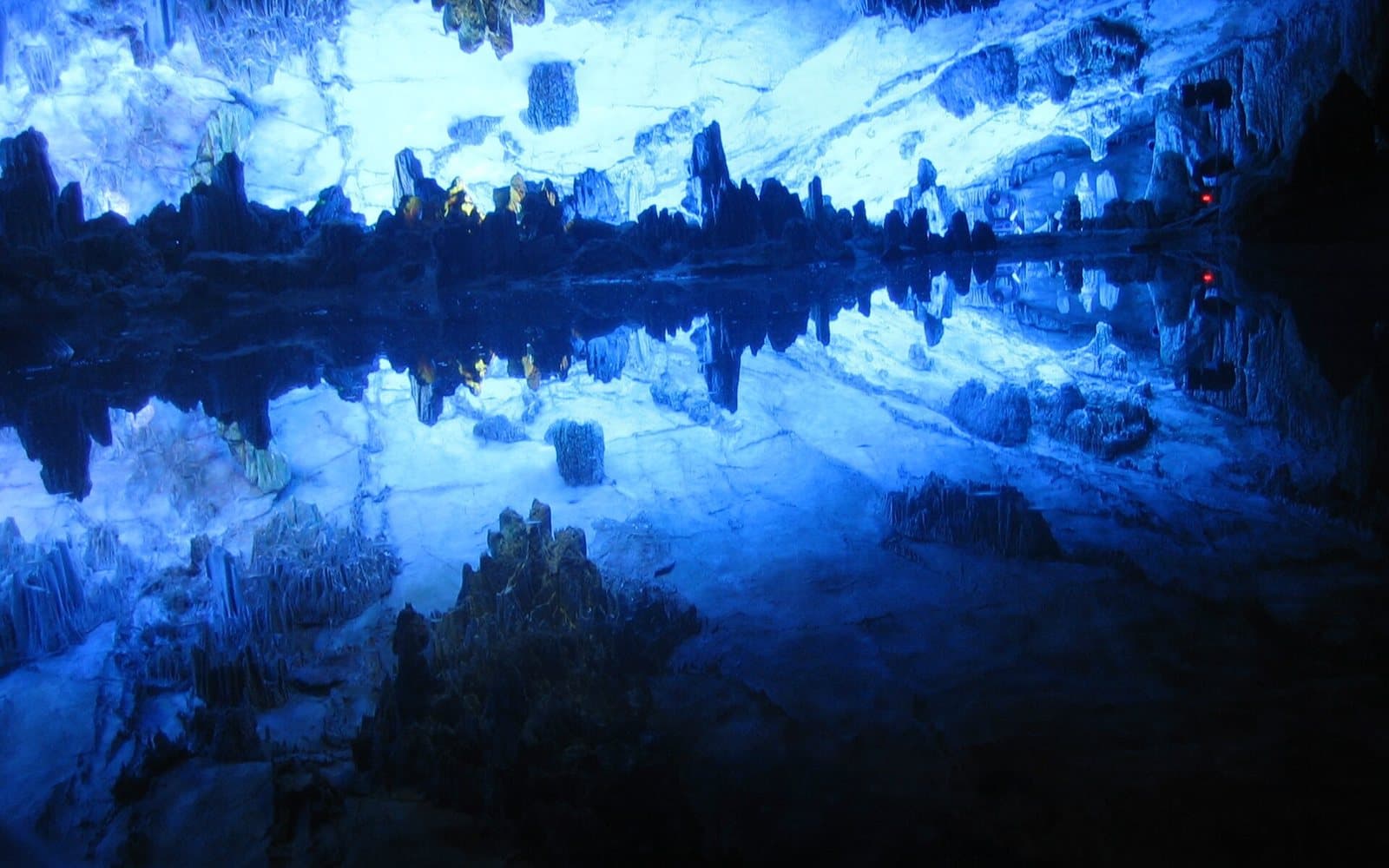 Illuminated stalactites and caverns inside Reed Flute Cave — view 1