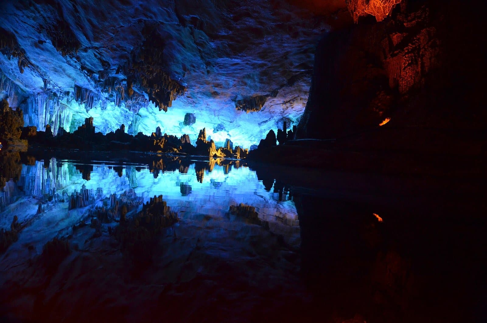 Illuminated stalactites and caverns inside Reed Flute Cave — view 2