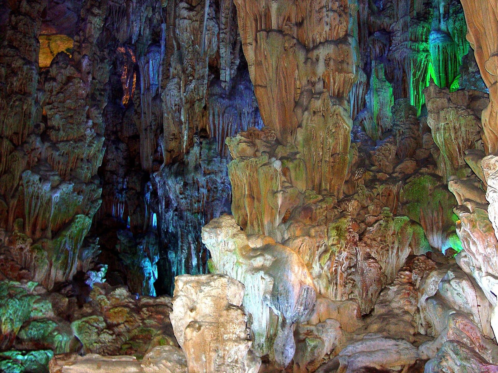 Illuminated stalactites and caverns inside Reed Flute Cave — view 3