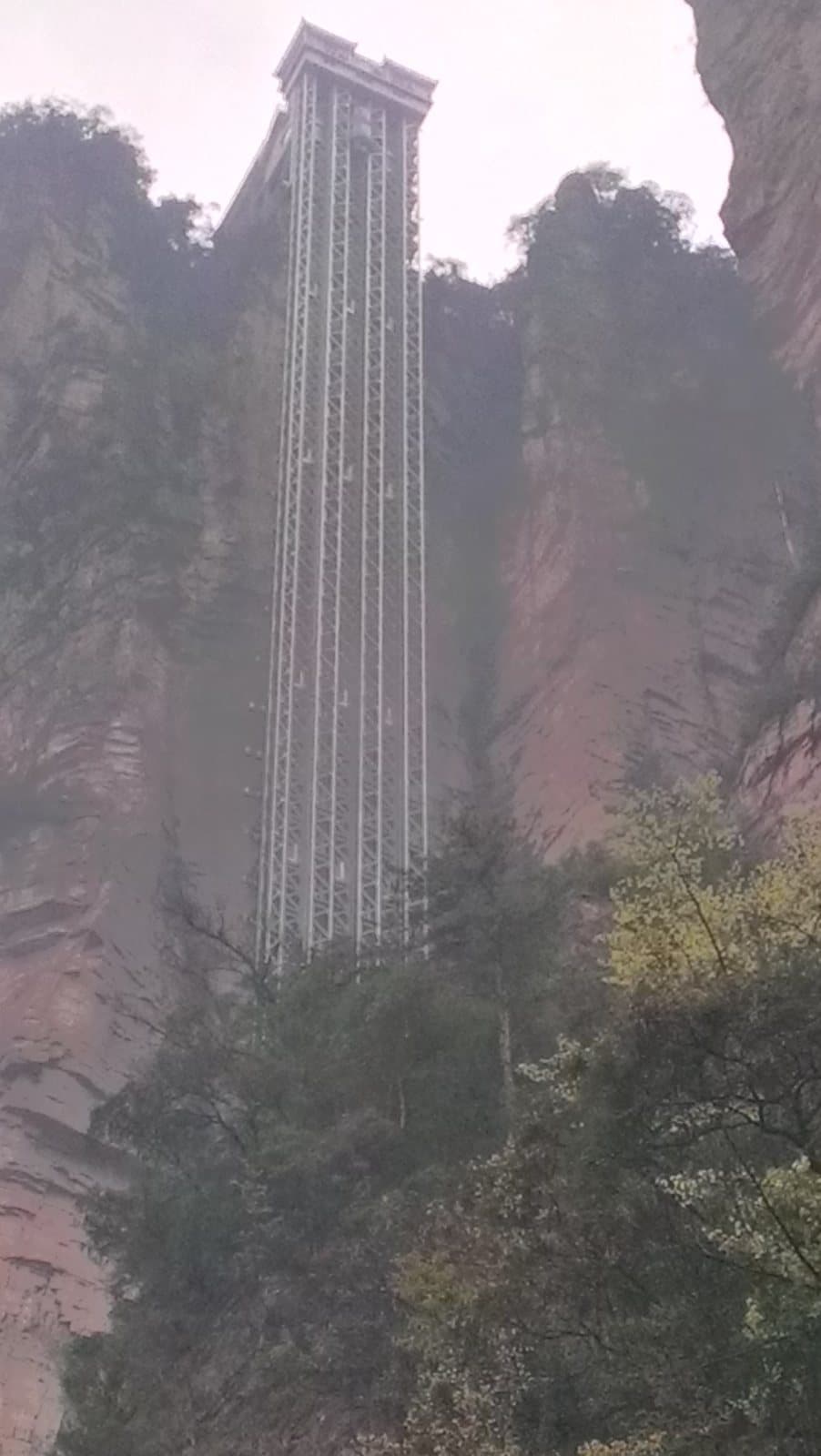 Bailong Elevator rising beside Zhangjiajie's sandstone cliffs — view 1