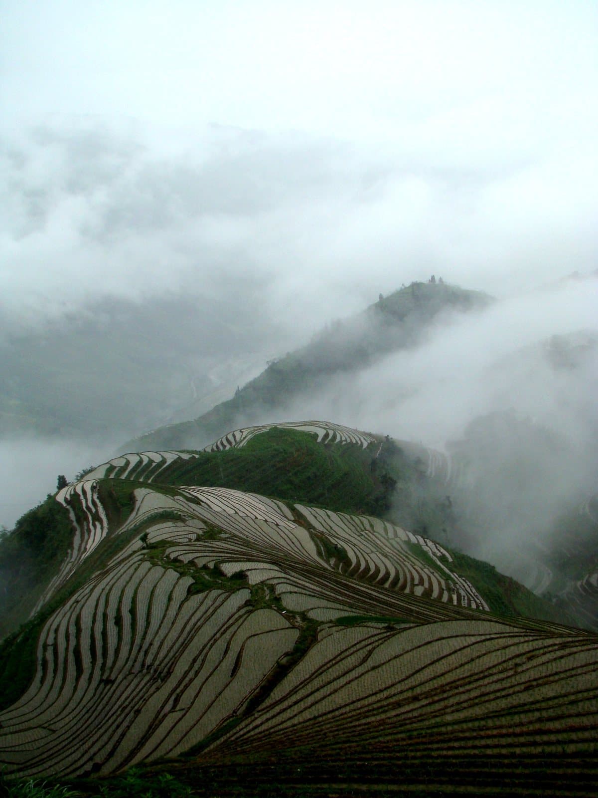 Layered rice terraces and mountain villages at Longji — view 2